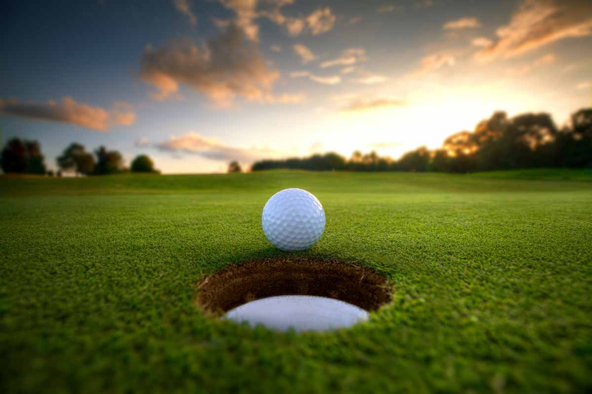 golf ball at edge of cup
